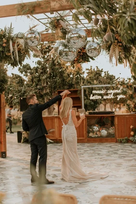 Wedding reception under a jungle pergola in Tulum, with hanging greenery and a lit dance floor