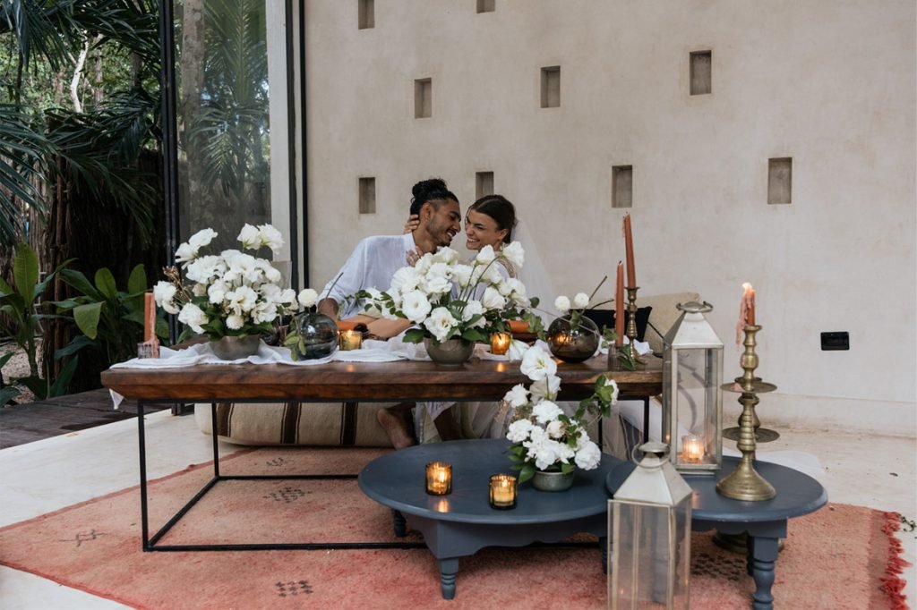 Newlyweds at a candlelit table at a jungle wedding venue in Tulum