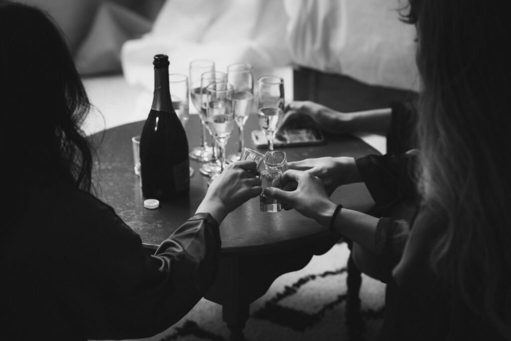 Two guests raising a toast over champagne glasses in a Tulum villa bedroom